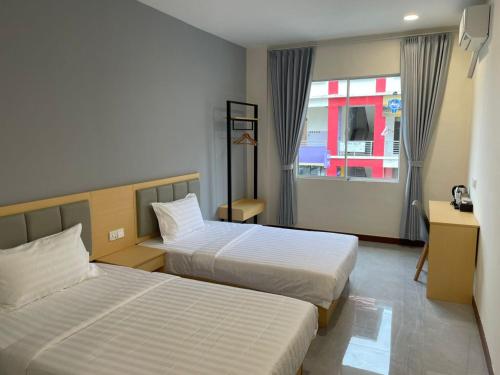 a hotel room with two beds and a window at Hotel Benoni in Papar