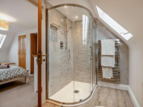 a bathroom with a glass shower in the attic at 3 Bed in Lulworth Cove DC139 in West Lulworth