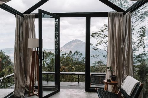 a room with a view of a mountain at Batur Cabins in Kintamani