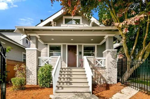 a house with a white staircase leading to the front door at Sunny 3BR Home Near UW & Children Hospital Gym in Seattle