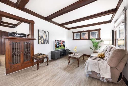 a living room with a couch and a tv at Sunny 3BR Home Near UW & Children Hospital Gym in Seattle