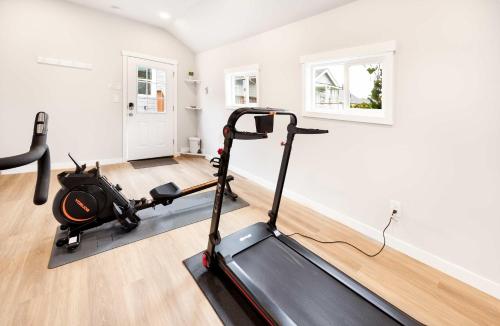 a gym with a treadmill in a room at Sunny 3BR Home Near UW & Children Hospital Gym in Seattle