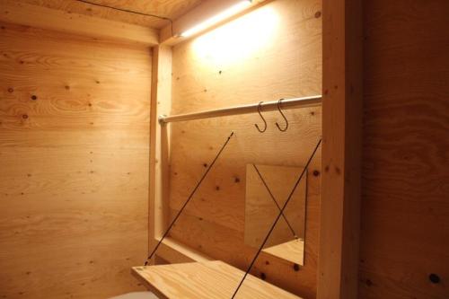 a inside of a wooden sauna with a light at Southern Gate HIVE in Ishigaki Island
