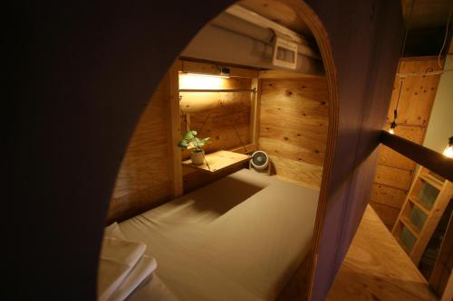 an overhead view of a bed in a wooden room at Southern Gate HIVE in Ishigaki Island