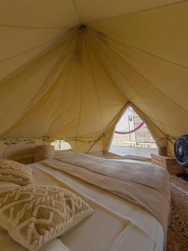 a bedroom with a large bed in a tent at Kitesurf Life Arpoador da Tutoia in Tutóia