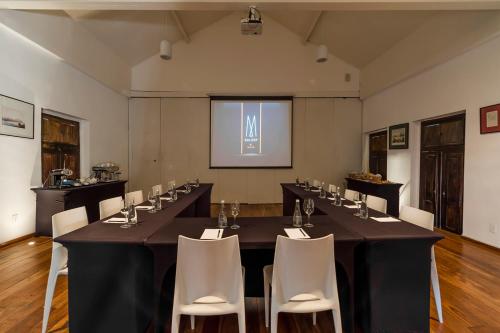 a conference room with a long table and chairs at Santa Teresa Hotel Rio de Janeiro - MGallery Collection in Rio de Janeiro