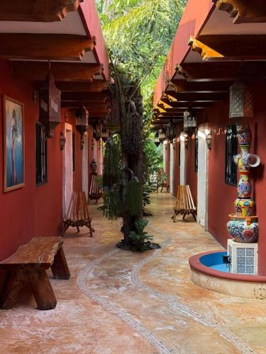 a courtyard of a house with a bench and a fountain at Real Haciendas in Valladolid