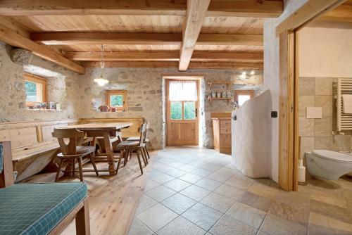 a kitchen with a table and a sink and a toilet at Chalet Bio Wild in Bocenago