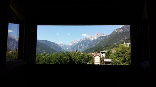a view from a window of a mountain range at Albergo Meublè Victoria in Auronzo di Cadore
