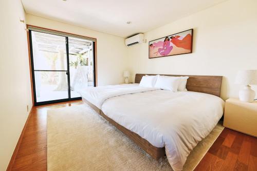 Postel nebo postele na pokoji v ubytování ウミヤマチクラ