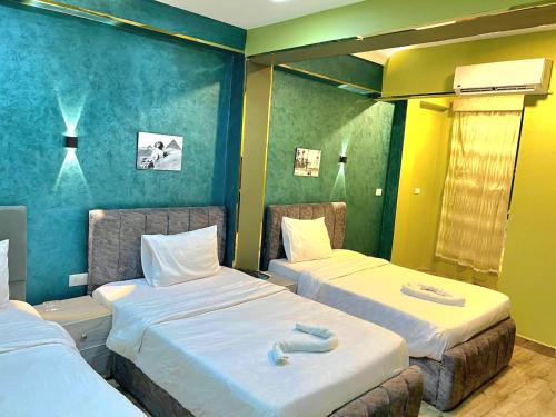 a room with two beds in a room at Elgabry pyramids inn in Cairo
