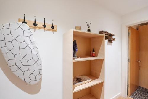 a room with white walls and white shelves at Beehive Salford Quays immaculate 1-Bed Flat with free-parking in Manchester