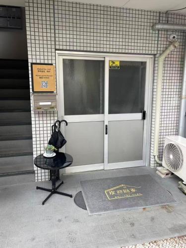a pair of doors on a building with a table at Nono in Takamatsu