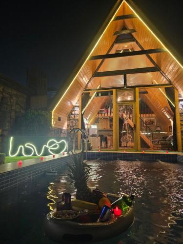 a pool at a resort at night with a restaurant at Baku Garden Aframe - Bungalov in Baku