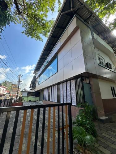 a building with a fence in front of it at Barkka in Ponnāni