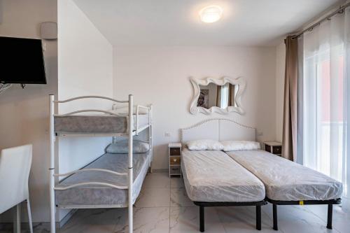 a bedroom with two bunk beds and a mirror at Planet Suite 203 in Bibione