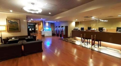 a lobby with couches and a bar in a building at Diamond Hotel Tokyo in Tokyo