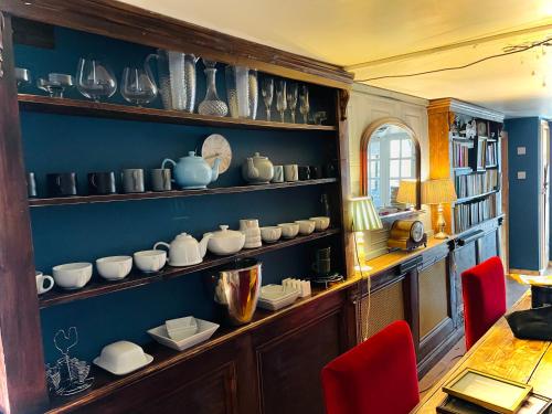 a room with shelves full of cups and dishes at Spacious Cabin with Private Hot Tub, and Private Pool, in 5 Acres - intimate Special stay For 2 Adults - plus 1 child under 2 and up to 2 dogs stay for free in Downham