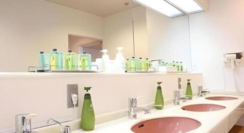 a bathroom with two sinks and a large mirror at Hotel Akai in Tokyo