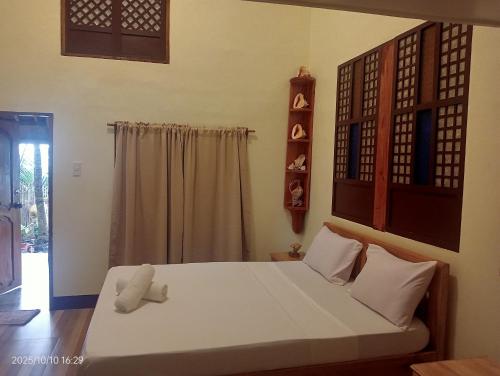 a bedroom with a large white bed in a room at Goldsky Seaview Resort in San Juan