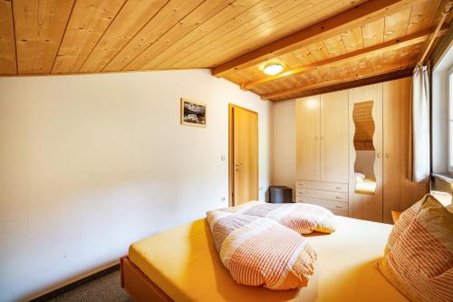 a bedroom with a bed with two pillows on it at Lingerhof Alpenrose in Meltina