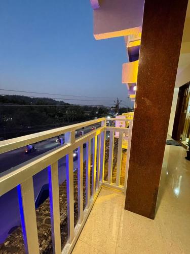 a balcony of a building with a view of the ocean at Hotel sai advika in Guirim
