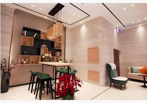 une salle à manger avec une table et des chaises vertes dans l'établissement City Comfort Inn Shenyang Railway Station Taiyuan Street Wanda Plaza, à Shenyang