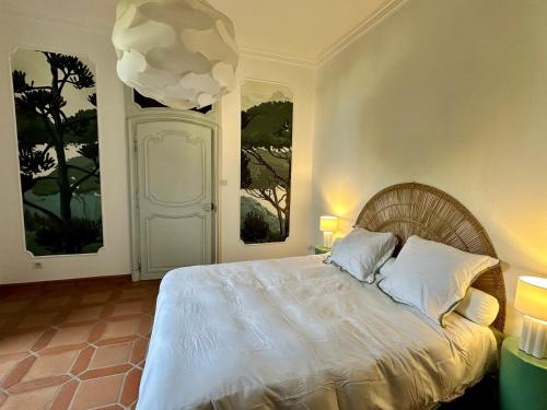 a bedroom with a white bed with two windows at Villa Alexandre III in Dijon