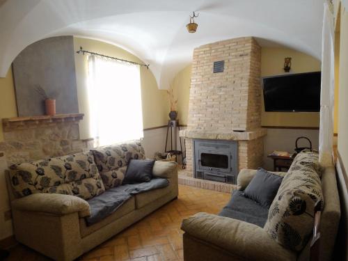 a living room with a couch and a fireplace at Casa Rural Doña Blanca in Santa Cruz de la Sierra