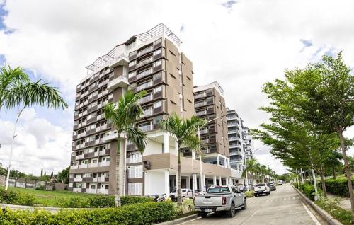 a tall apartment building with cars parked in front of it at Charming Modern 1 BR Loft in Sampong
