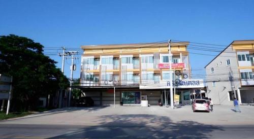 a building with a car parked in front of it at Crystal Place Prathai in Prathai