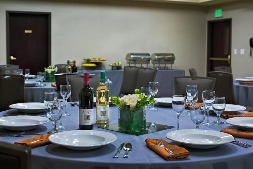 a table with plates and wine bottles and glasses at Oxford Suites Spokane Downtown in Spokane