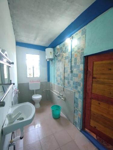 a bathroom with a toilet and a tub and a sink at Betzer homestay in Cherrapunji