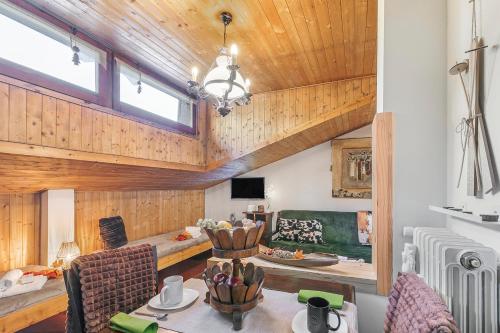a living room with a couch and a table at Studio Valleverde 33B Ski in Ski Out - Happy Rentals in Sestriere