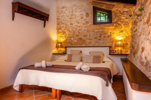 a bedroom with a bed with two towels on it at Es Forn in Petra