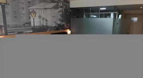 a kitchen with a counter top and a window at Thank Hotel Shandong Weifang North High-speed Railway Station in Weixian