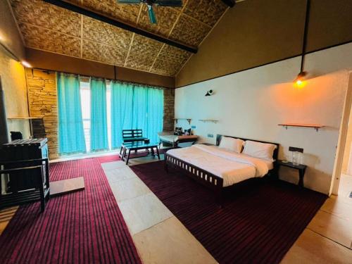 een slaapkamer met een bed en een woonkamer bij Villa Himalayan Trove in Jāmb