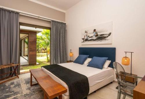 une chambre avec un lit, une table et une fenêtre dans l'établissement Royal Park Resort & Villas, à Arsenal