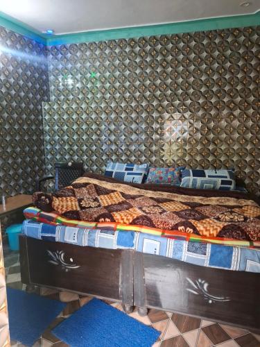 a bedroom with a large bed in a room at Akash Kamini Homestay in Chopta