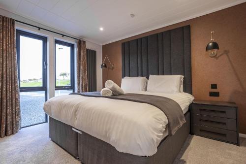 a bedroom with a large bed and a large window at Lodge No 147 - Stewarts Resort Cameron in Cameron