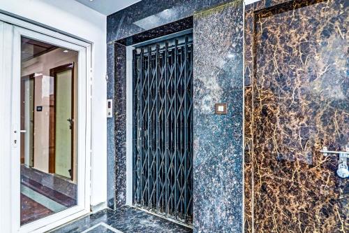 a bathroom with a shower with blue marble walls at Heavens Inn Near Rasoolpura metro station in Secunderabad