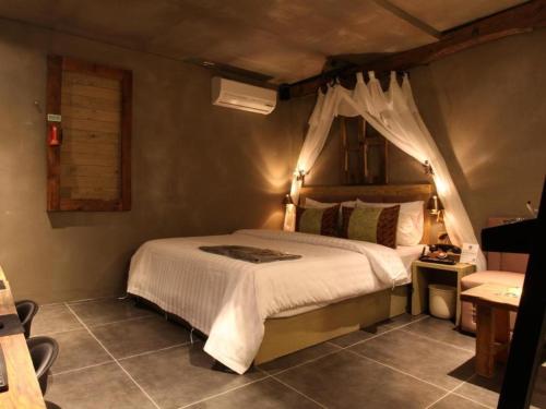 Postel nebo postele na pokoji v ubytování Mac Hotel