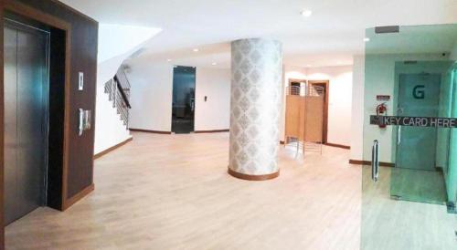 a room with a column in the middle of a building at The Y Residence in Chiang Mai