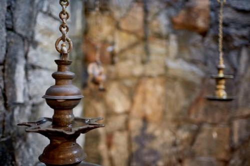 a close up of a wooden object in front of a wall at Bamboo Villa Kandy in Digana