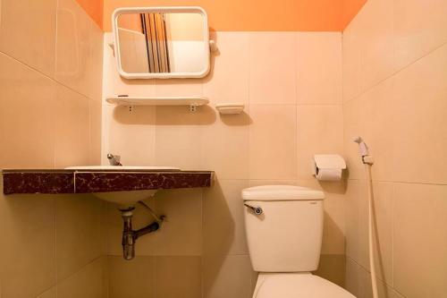 a bathroom with a toilet and a sink and a mirror at Happy Zone Hostel in Siem Reap