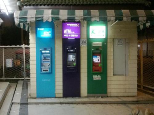 two atm machines on the side of a building at T8 Guest House Don Mueang Challenger in Bangkok