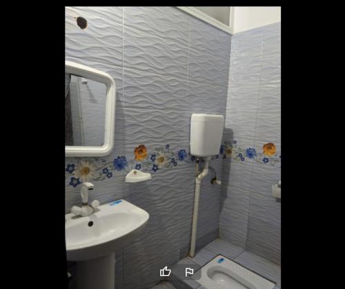 a bathroom with a sink and a mirror at High City Hotel in Dargai
