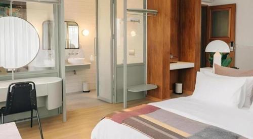 a bedroom with a bed and a bathroom with a sink at The House Tour Middletown in Bandung