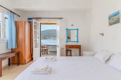 a bedroom with a bed and a view of the ocean at Sifnos studio 6 in Sifnos