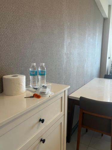 two bottles of water sitting on top of a dresser at Exec 1BR One Manchester Place with pool, beach pass is P 350 pp in Punta Engaño